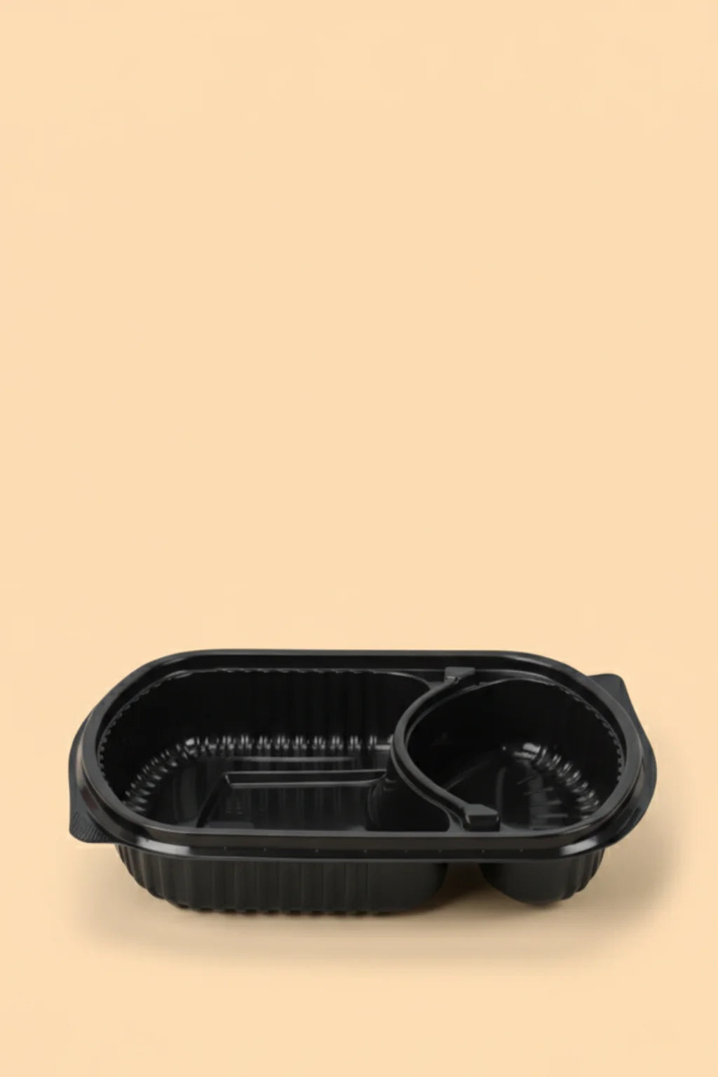 Black plastic food container on a beige background